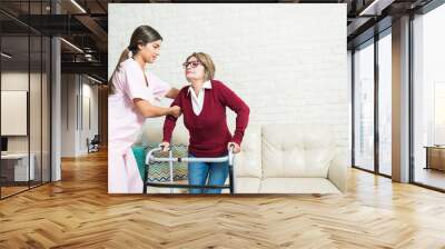 Nurse Supporting Elderly Patient At Home Wall mural