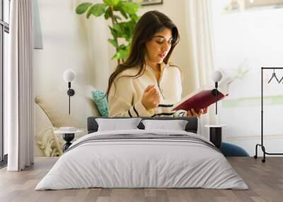 Spiritual woman reading the bible saying a prayer Wall mural