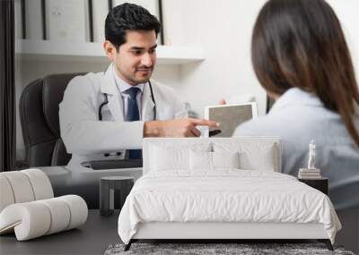 Surgeon Discussing With Woman Over MRI Scan Wall mural