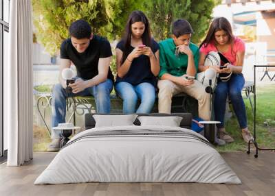 Teens busy with cell phones Wall mural