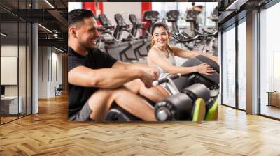 Woman flirting with a guy in a gym Wall mural