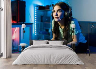 Woman using headphones and a microphone for a videogame Wall mural