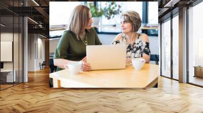 Women meeting at cafe for work Wall mural