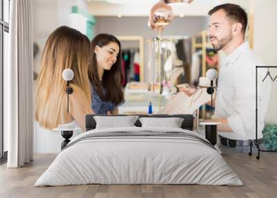 Young man selling jewelry to women Wall mural