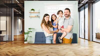 Young mom, dad and kids posing for a photo Wall mural