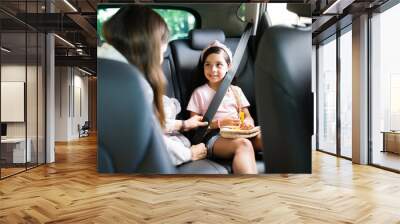 Young woman talking with their children in the car Wall mural