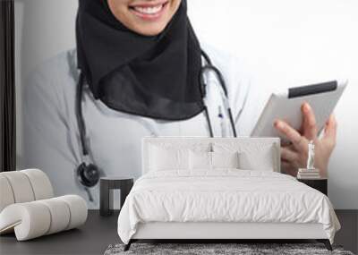 Arab doctor woman with a tablet looking at camera Wall mural