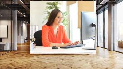 Businesswoman working typing in a desktop computer Wall mural