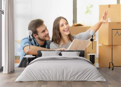 Couple planning decoration when moving home Wall mural