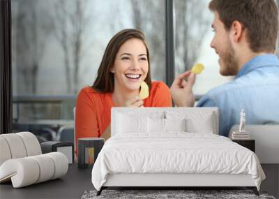 Couple talking and eating chip potatoes Wall mural