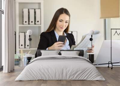 Executive checking news in a phone and newspaper Wall mural