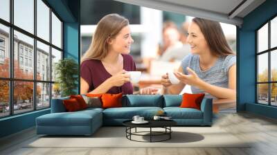 Happy friends having a conversation in a bar Wall mural