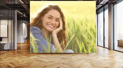 Happy woman smiling at camera in a wheat field Wall mural