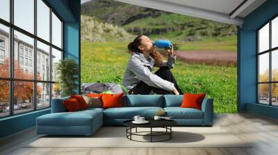 hiker drinking water from canteen in a mountain Wall mural