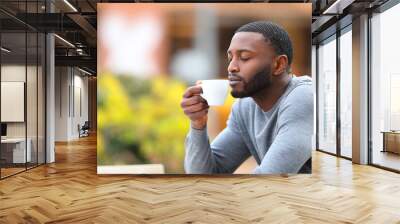 Man with black skin enjoying aroma of coffee cup Wall mural