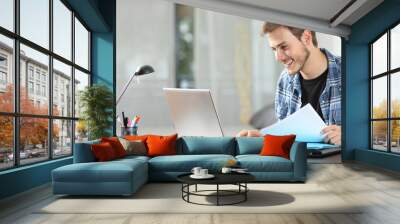 Man working online at home on a laptop Wall mural