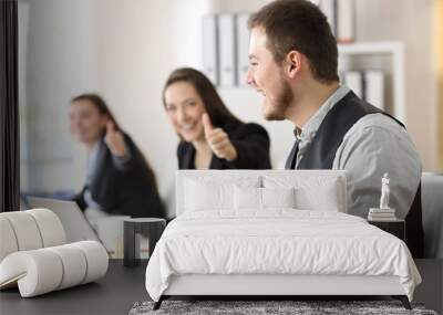 Proud employee being congratulated by colleagues Wall mural