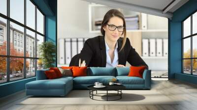 Proud office worker wearing eyeglasses looking at camera Wall mural