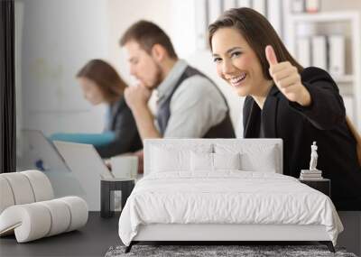 Satisfied business woman with thumbs up Wall mural