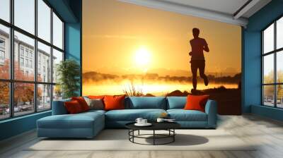 Silhouette of a man running at sunrise Wall mural