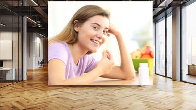 Teen taking omega 3 vitamin pill Wall mural