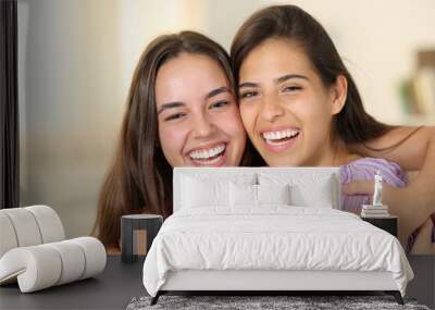 Two happy women with perfect smiles at home Wall mural