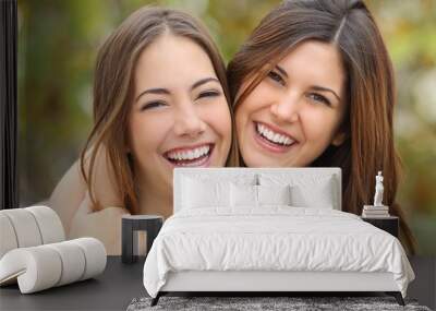 two women friends laughing with a perfect white teeth Wall mural