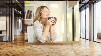 woman breathing holding a coffee mug at home Wall mural