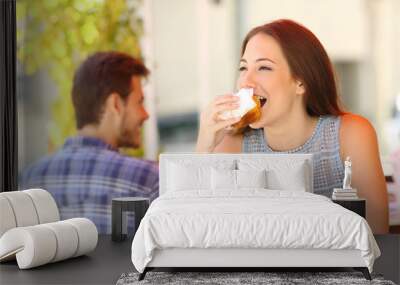 Woman eating a cupcake in a coffee shop Wall mural