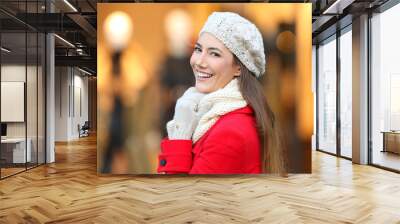 Woman smiling at camera in winter in a mall Wall mural