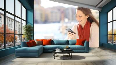 Woman using a smart phone in a coffee shop on vacation Wall mural