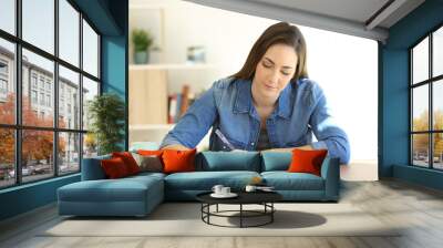 Woman writing a letter on a table at home Wall mural