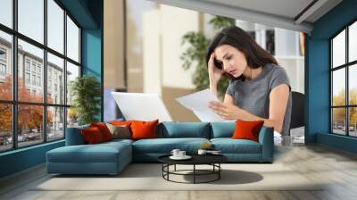 Worried office worker reading bad news in a letter Wall mural