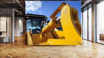 bulldozer, huge yellow powerful construction machine with big scoop, focused on hydraulic piston arm Wall mural