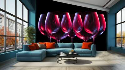 Wine glasses lit by red, blue, lilac nightclub party lights on black background  Wall mural