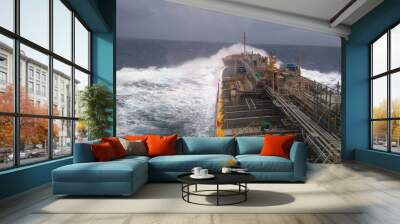 A merchant ship underway at sea in rough weather Wall mural