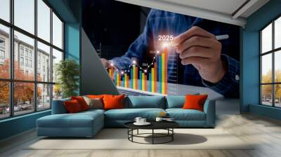 Business growth year 2024 to 2025. Businessman analyzes profitability of working companies with digital augmented reality graphics and calculates financial data for long-term investments. Wall mural