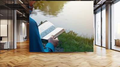 Man Reading Bible By Lake Wall mural