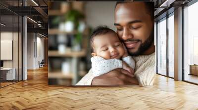 A black man father smiles warmly while holding his sleeping baby close, capturing a tender and joyful moment Wall mural