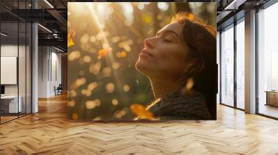 A serene woman enjoys forest bathing session, surrounded by sunlight and falling leaves Wall mural