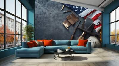 Assorted construction tools with American flag on rugged surface, labor and patriotism Wall mural