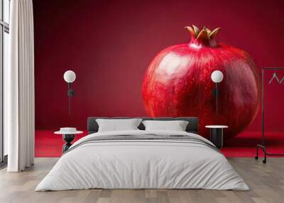 Extreme close-up shot of a vibrant pomegranate against a solid light red backdrop Wall mural