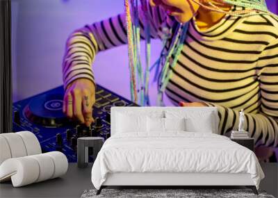 Asian girl DJ is playing a turntable in night party is colorful. Wall mural