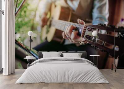 Musician playing guitar at a party. Wall mural