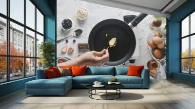 Making pancakes, cake, baking top view of baker hands pouring or scoop the batter onto the pan. Concept of Cooking ingredients and method on white marble background, Dessert recipes and homemade. Wall mural