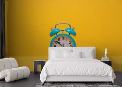 Blue Alarm Clock on Yellow Background. Wall mural