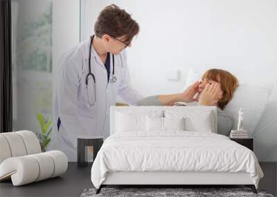 Doctor examining a senior woman in the ward at hospital or medical clinic Wall mural