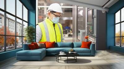 engineering working in factory concept.Selective focus Technician worker in manufacturing plant at machine control panel. Foreman engineer man wear safety helmet standing. Wall mural