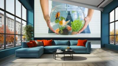 man holding fish tank Wall mural