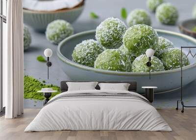 A bowl of green balls with coconut flakes on top Wall mural